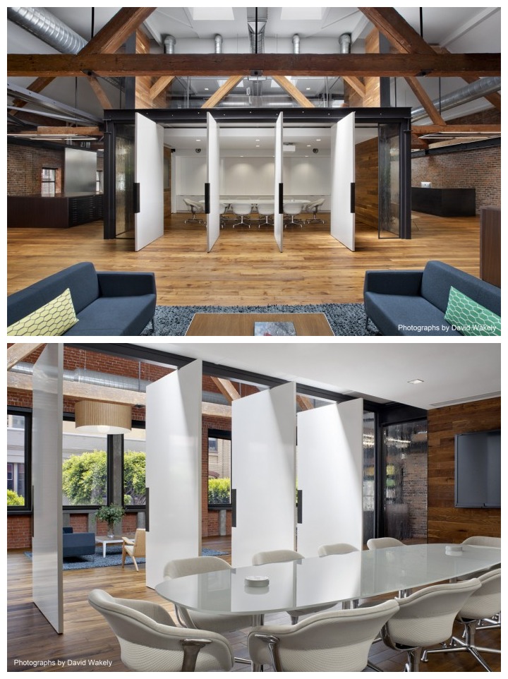 Open concept office with natural wood beams and swinging boardroom doors