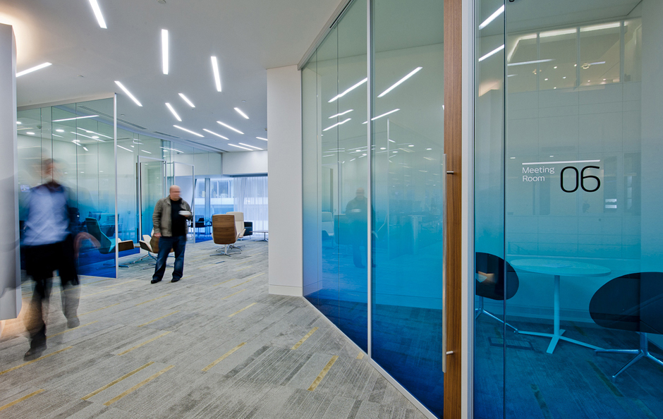 Bright open modern office space with graduated glass walls for privacy